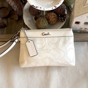 Coach cream color laser cut leather wristlet with silver hardware